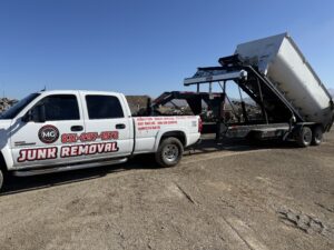 Home 26 MG Transportation pickup truck next to open dump truck during active and hauling operations
