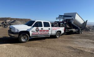 MG Transportation dump truck at gravel lot, demonstrating debris removal and demolition waste hauling capabilities.